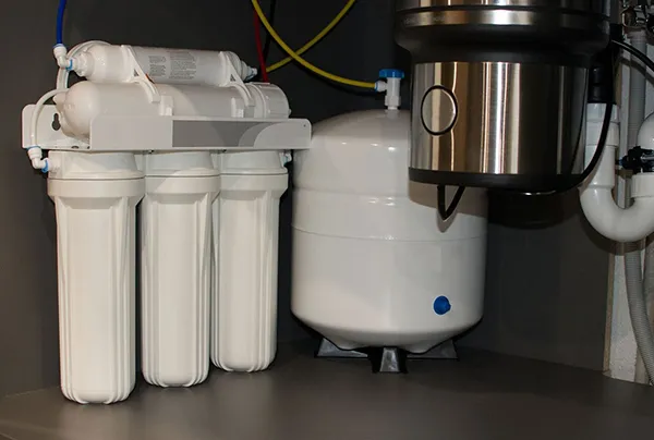 Close-up of advanced water filtration system components installed beneath kitchen sink in Lancaster TX.