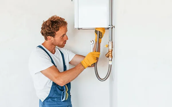 Technician installing modern water heating solutions in Forney TX